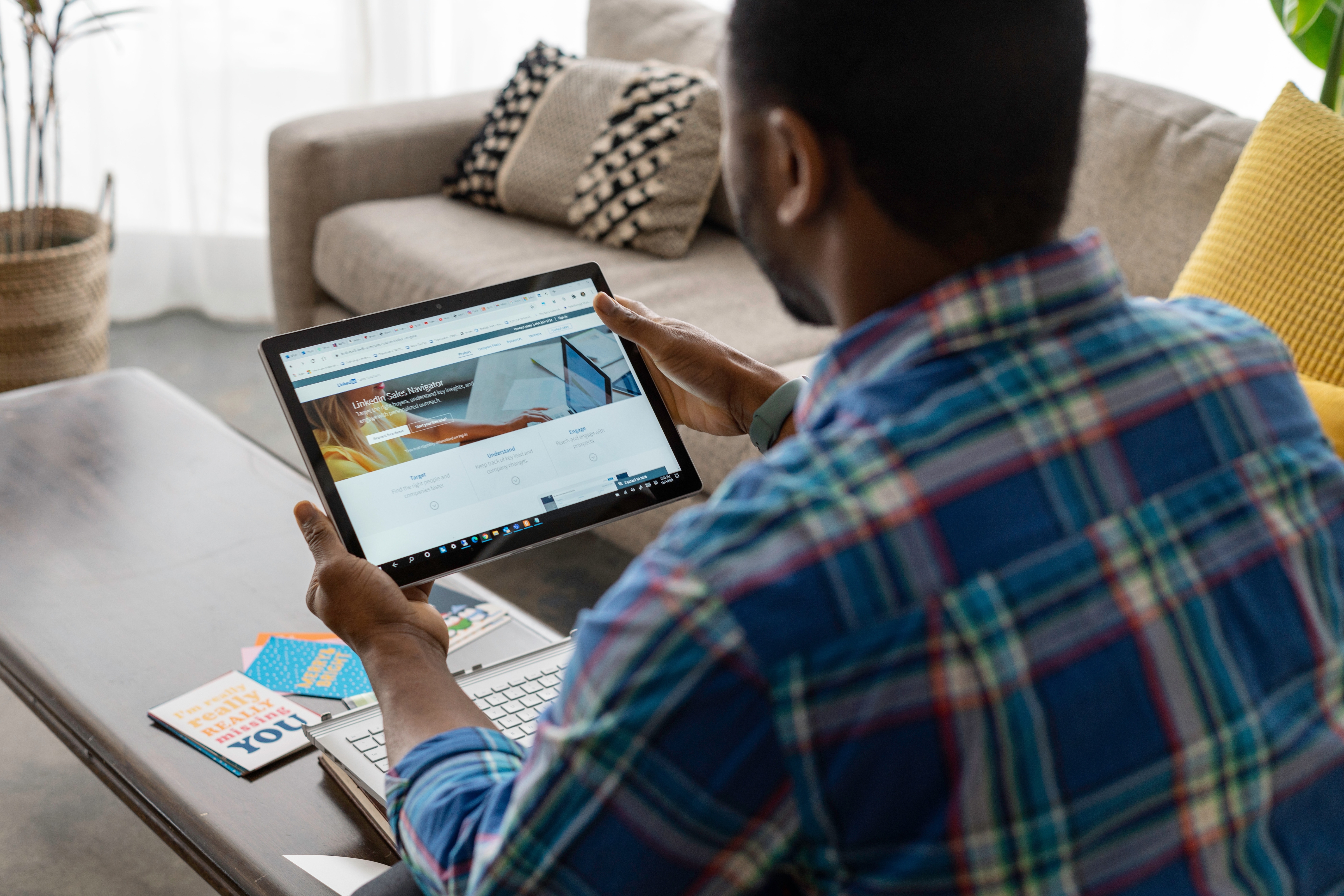 Photo of a guy accessing his LinkedIn Account with his iPad